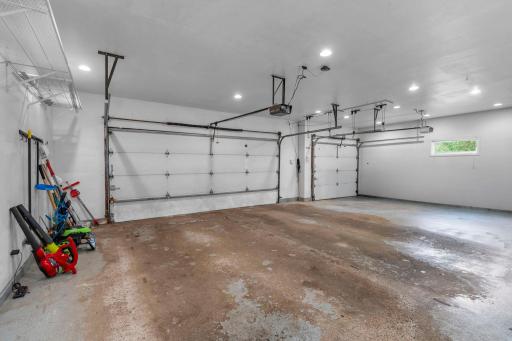 Ultra-spacious, sheetrocked 3-car attached garage offering premium recessed lighting and plenty of workspace.