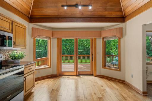 Sun-lit glass sliders frame peaceful backyard views and provide seamless indoor-outdoor entertaining flow.