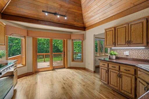 Charming breakfast nook or casual dining area right off the kitchen, featuring sliding glass doors to the deck.