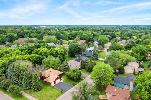 Aerial perspective showing the home nestled in a highly desirable, tree-lined neighborhood