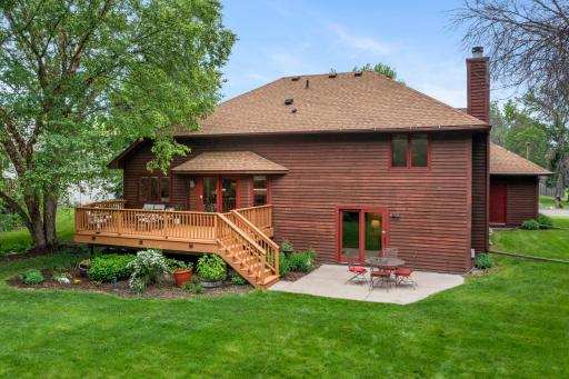 Wide shot of the expansive backyard retreat, complete with detailed flower beds and landscaping.