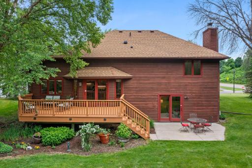 Full rear elevation showing the double deck and patio layout against the classic cedar siding.