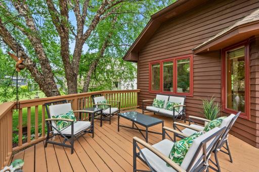 Serene outdoor retreat showing the direct connection between the kitchen dining space and the vast wooden deck.