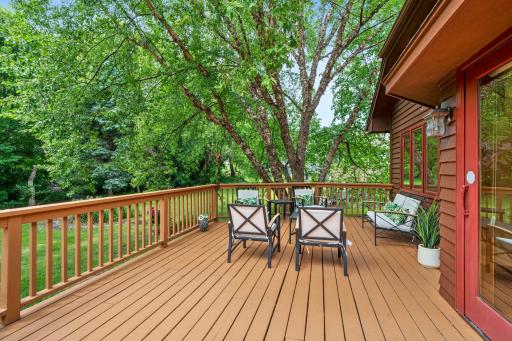 Expansive wood deck overlooking the beautiful backyardâan absolute haven for summer grilling and outdoor entertaining.