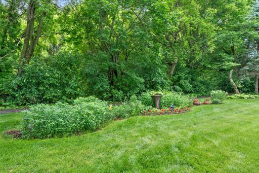 Detailed view of the custom garden beds and decorative planter that perfectly accent the edge of the lawn.