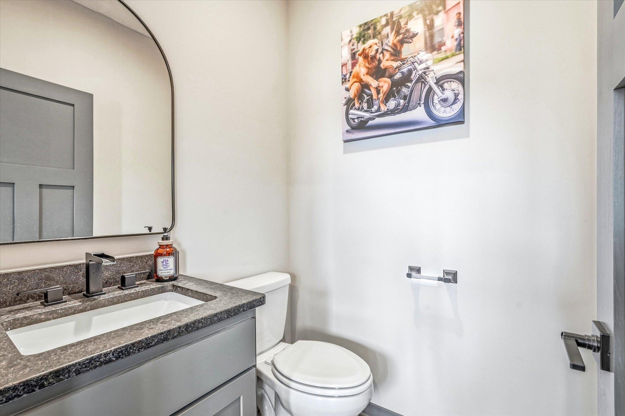 Stylish main-level half bath featuring modern fixtures, sleek vanity, and contemporary finishes.