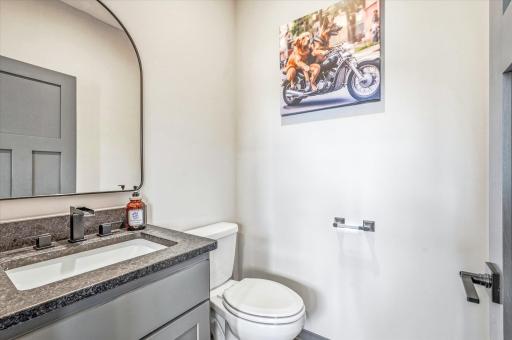 Stylish main-level half bath featuring modern fixtures, sleek vanity, and contemporary finishes.