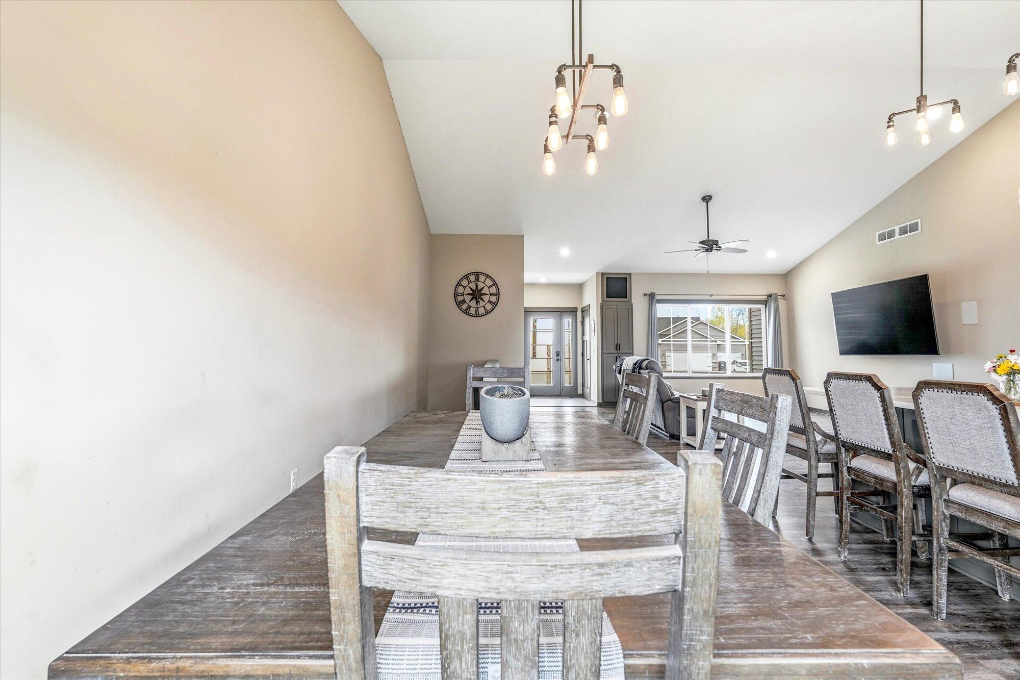 Spacious dining area with stylish lighting and sliding glass door leading to the backyard and future outdoor entertaining space.