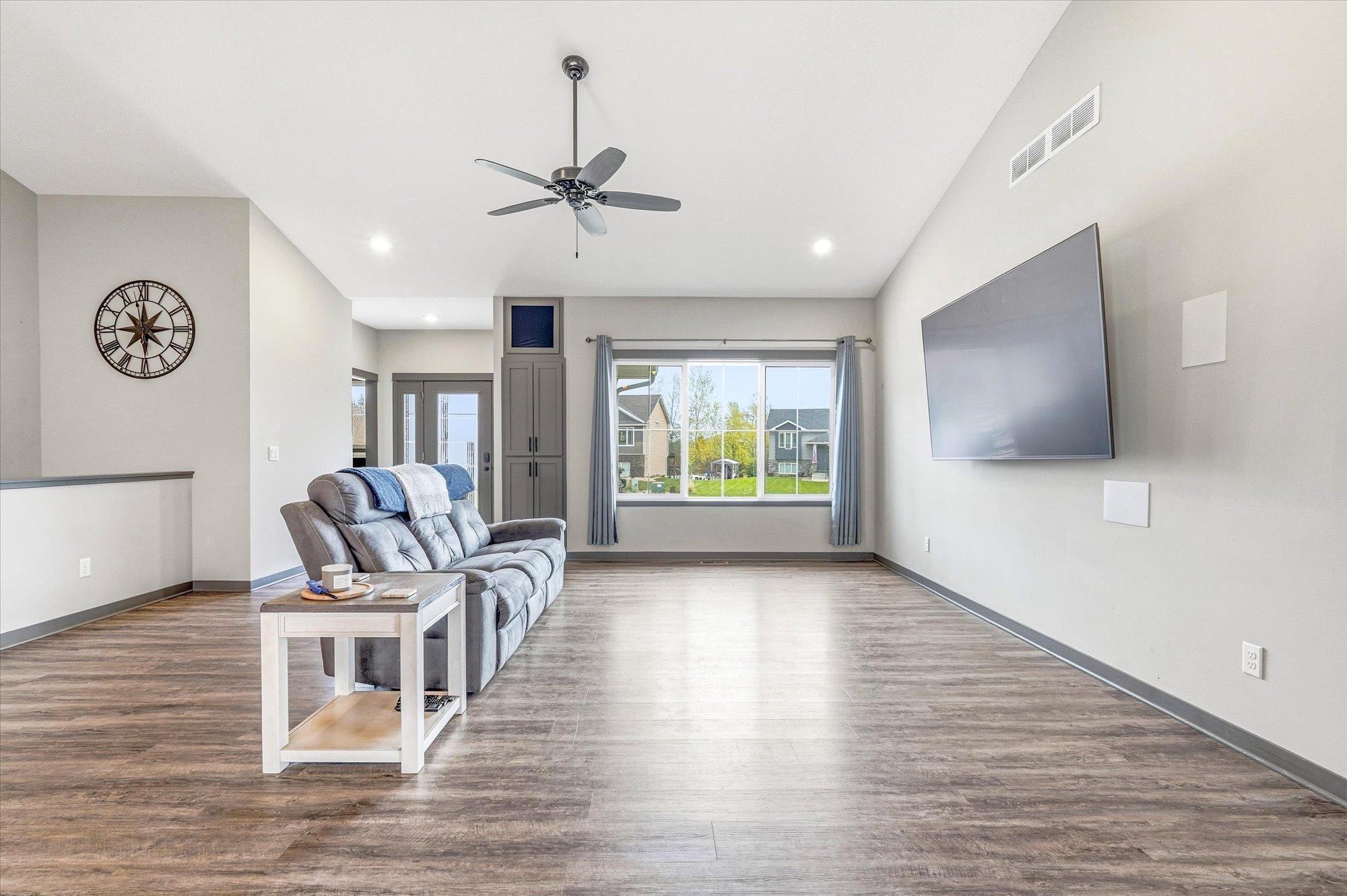 Beautiful great room with vaulted ceilings, recessed lighting, and seamless flow into the kitchen and dining areas.