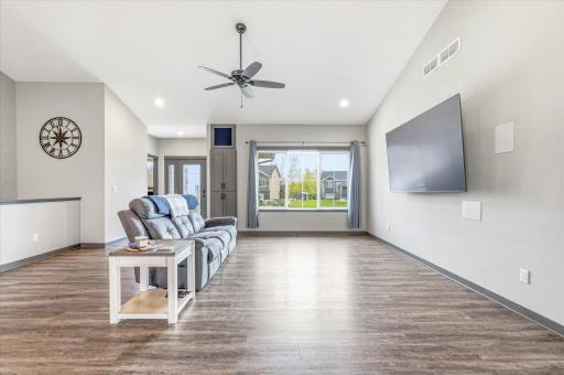 Beautiful great room with vaulted ceilings, recessed lighting, and seamless flow into the kitchen and dining areas.