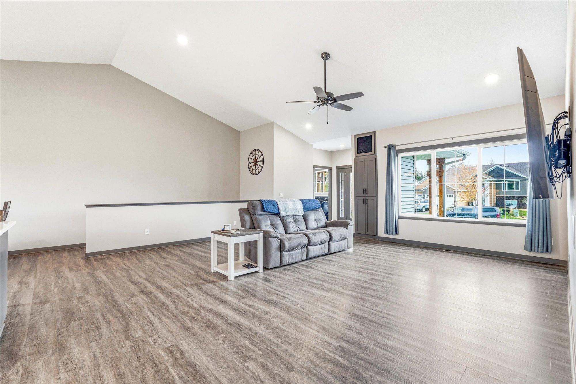 Oversized living room with large picture window and plenty of space for gatherings, movie nights, or relaxing at home.