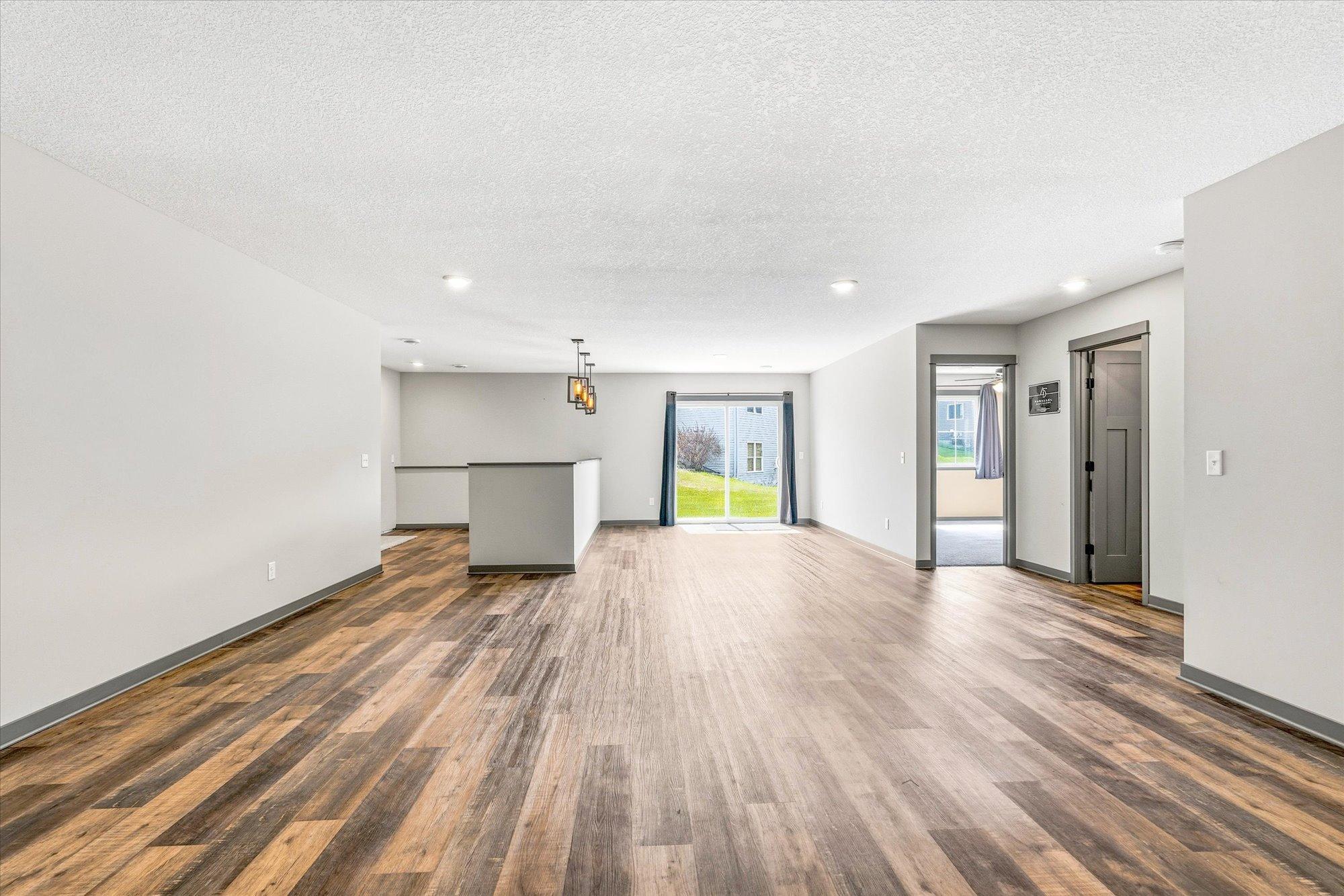 Expansive lower-level family room offers endless possibilities for entertaining, recreation, or a future theater space.