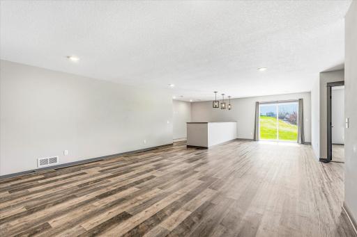 Bright and spacious walkout lower level features durable flooring, recessed lighting, and access to the backyard.