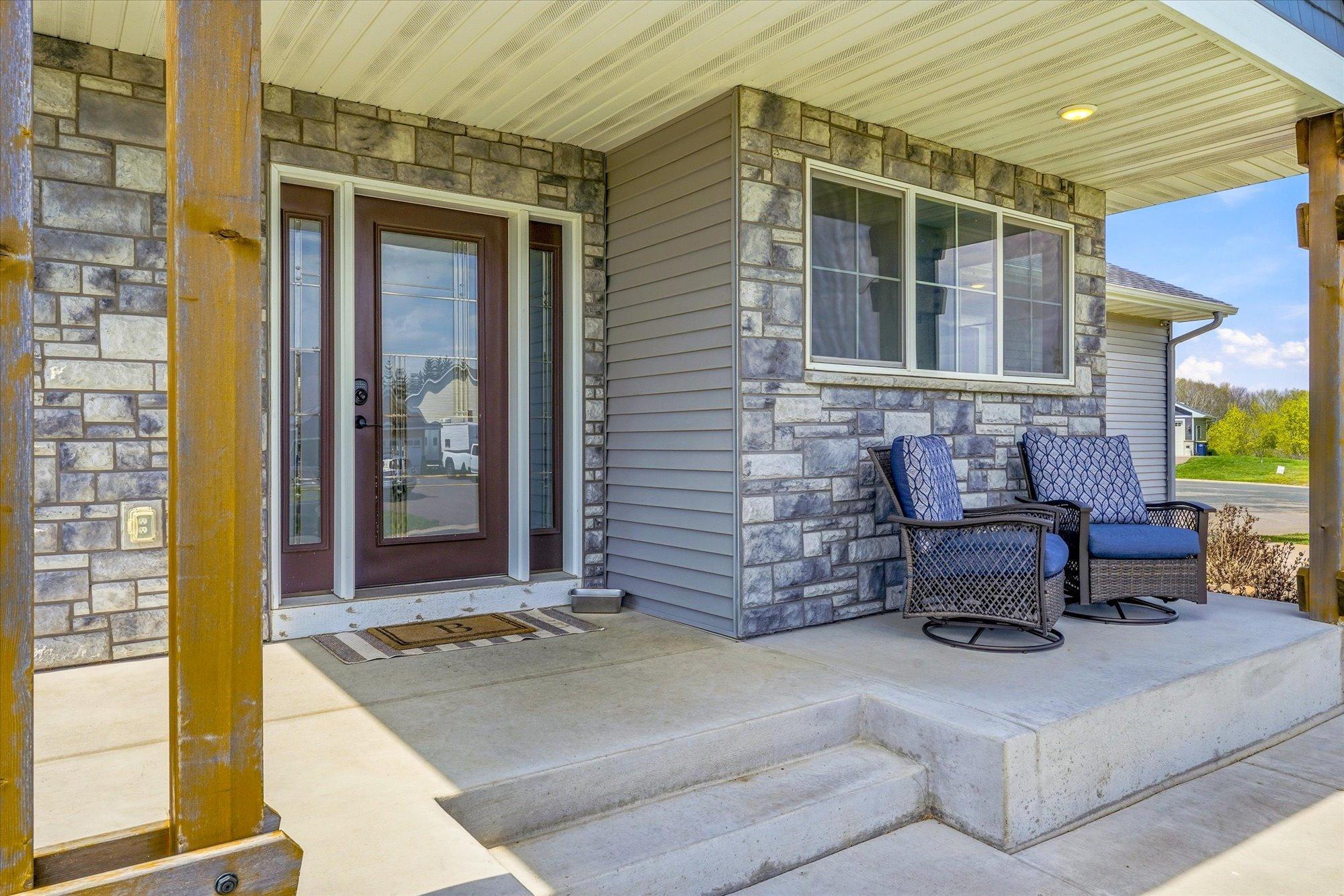 Covered front porch provides a warm and welcoming entrance with plenty of room for outdoor seating.