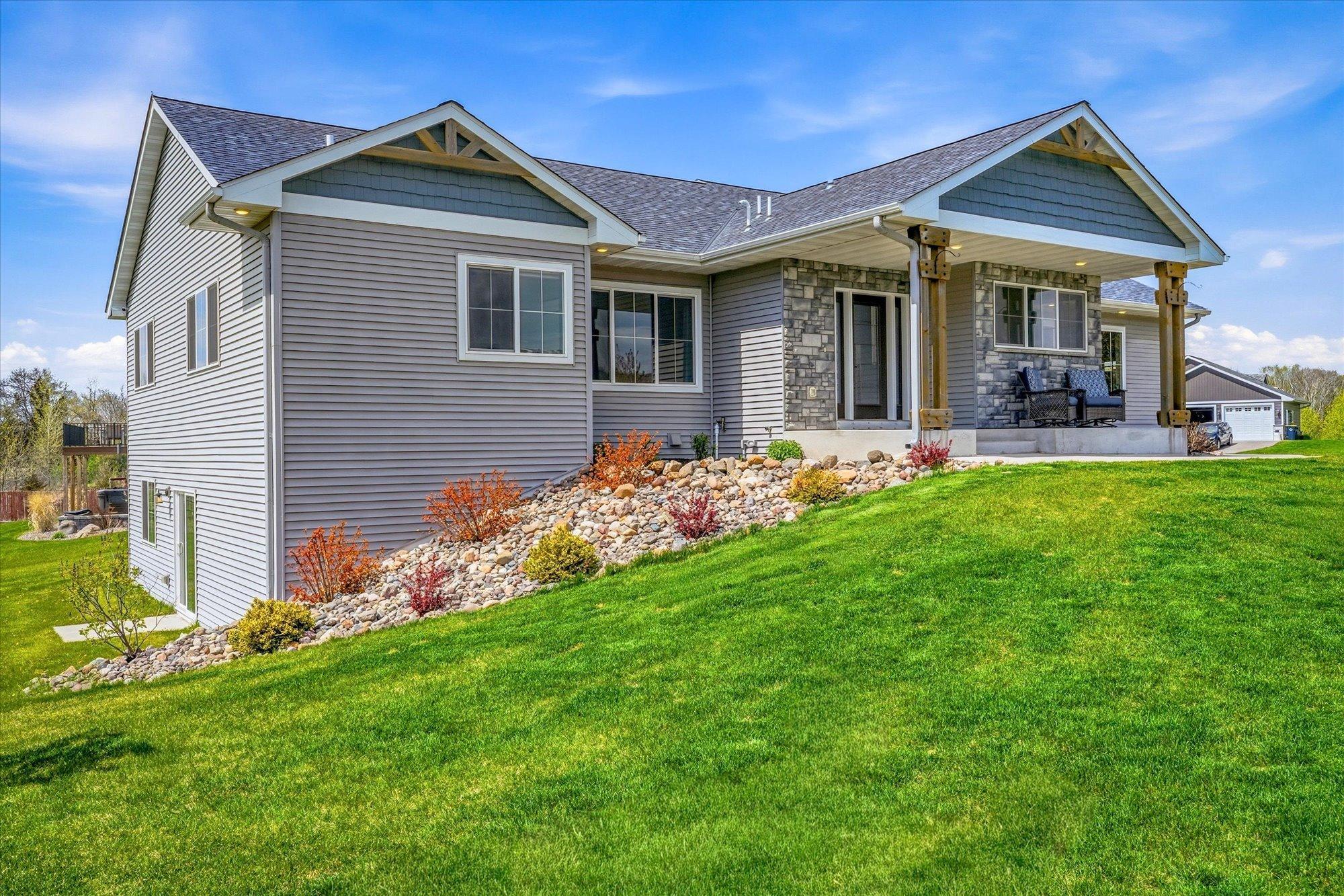 Stunning custom-built rambler with exceptional curb appeal, attractive stone accents, and beautifully maintained landscaping in a desirable Lindstrom neighborhood.