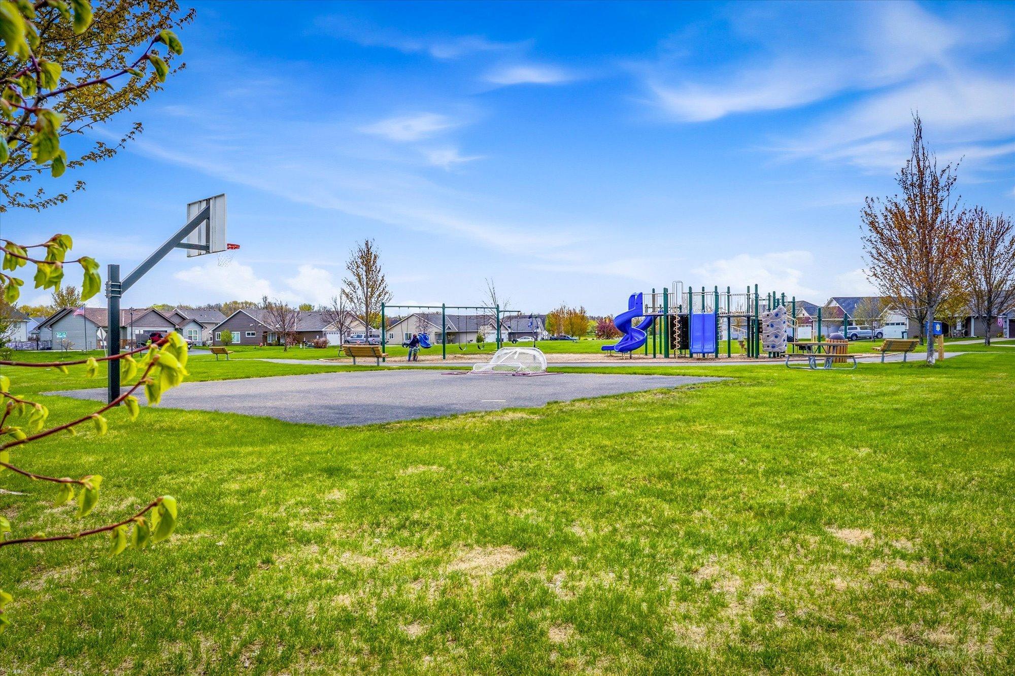 Neighborhood park nearby features playground equipment, basketball court, open green space, and gathering areas for outdoor enjoyment.