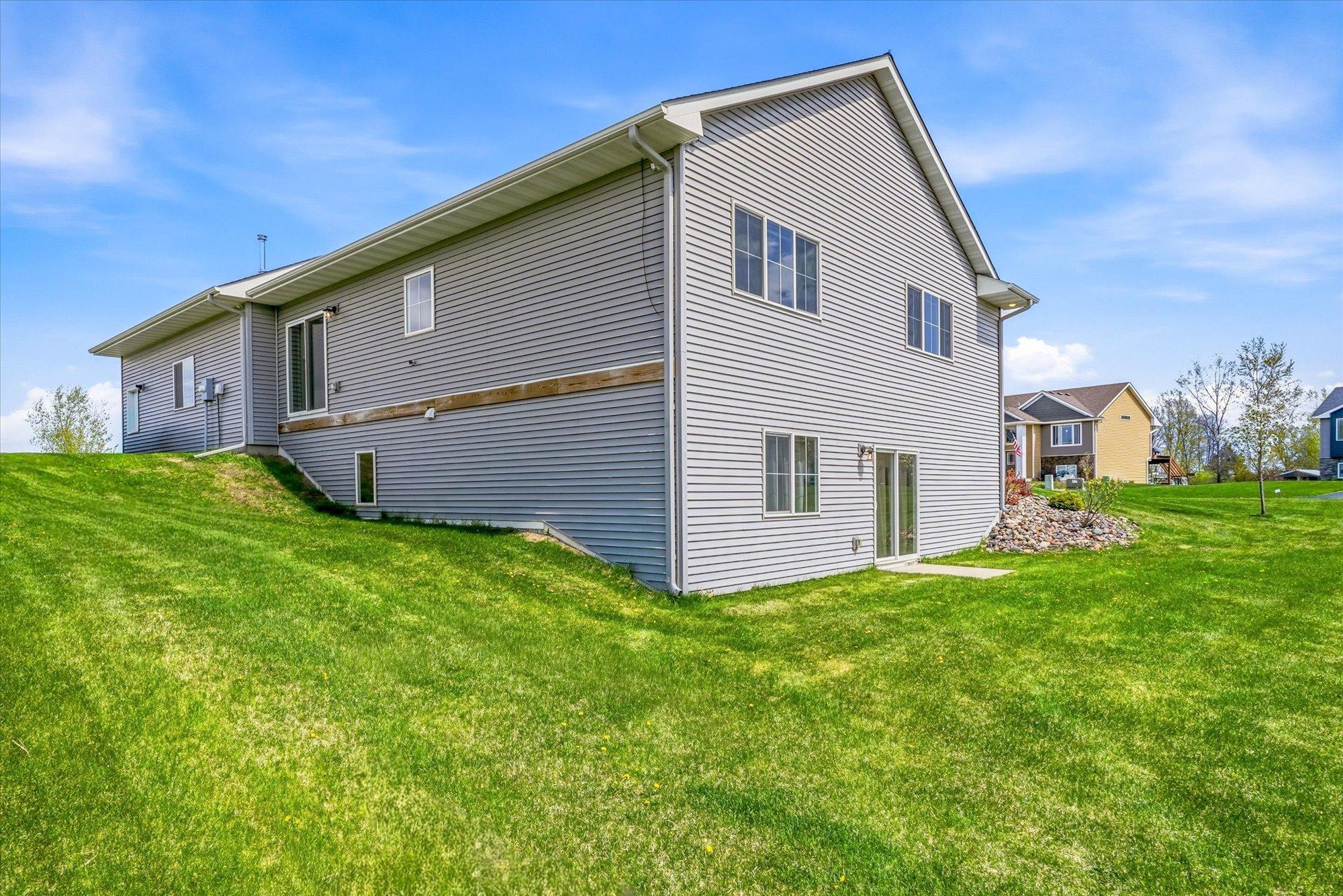 Walkout lower level opens directly to the backyard, offering easy outdoor access and future patio potential.