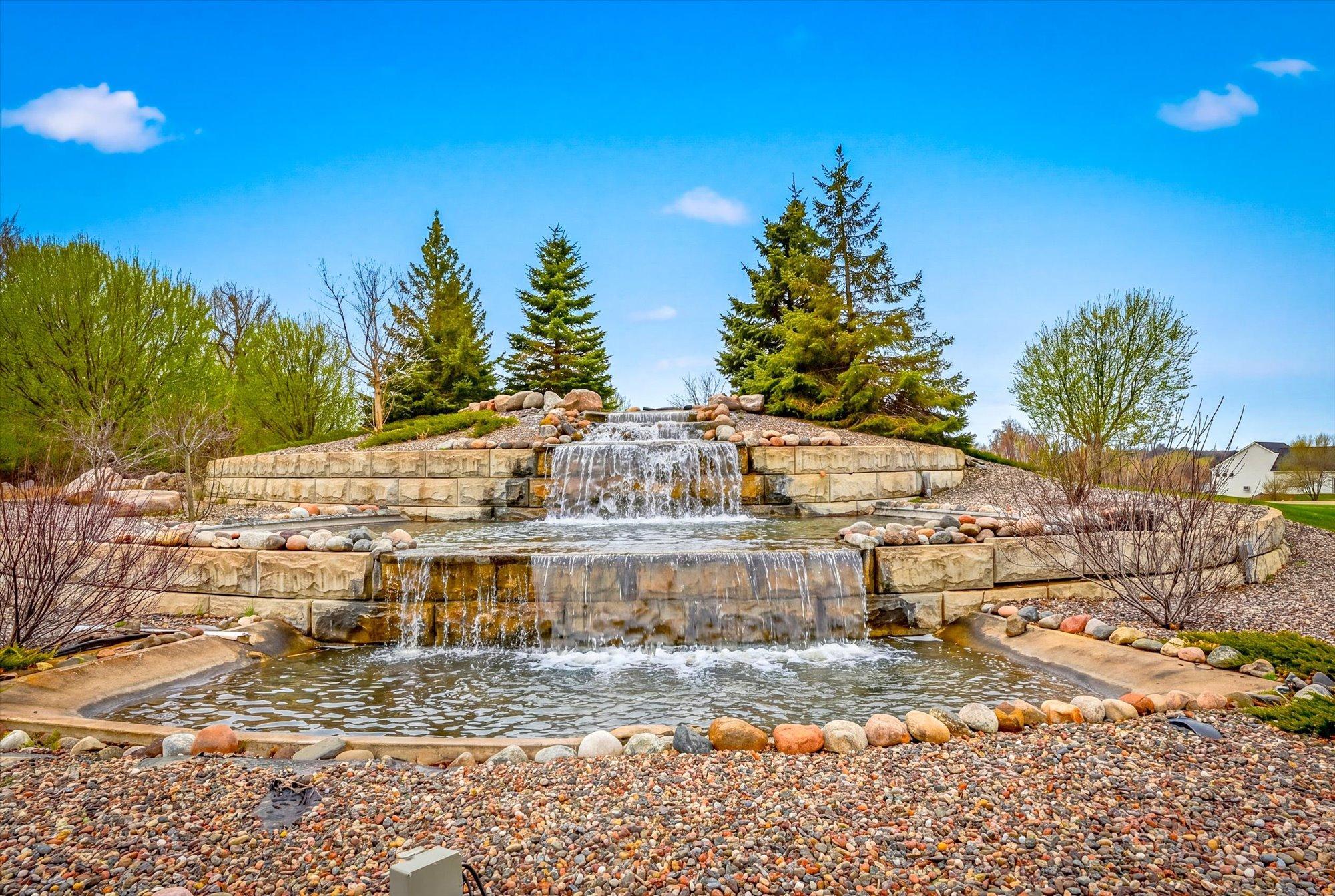 A beautiful waterfall invites you into one of the entrances of this neighborhood.