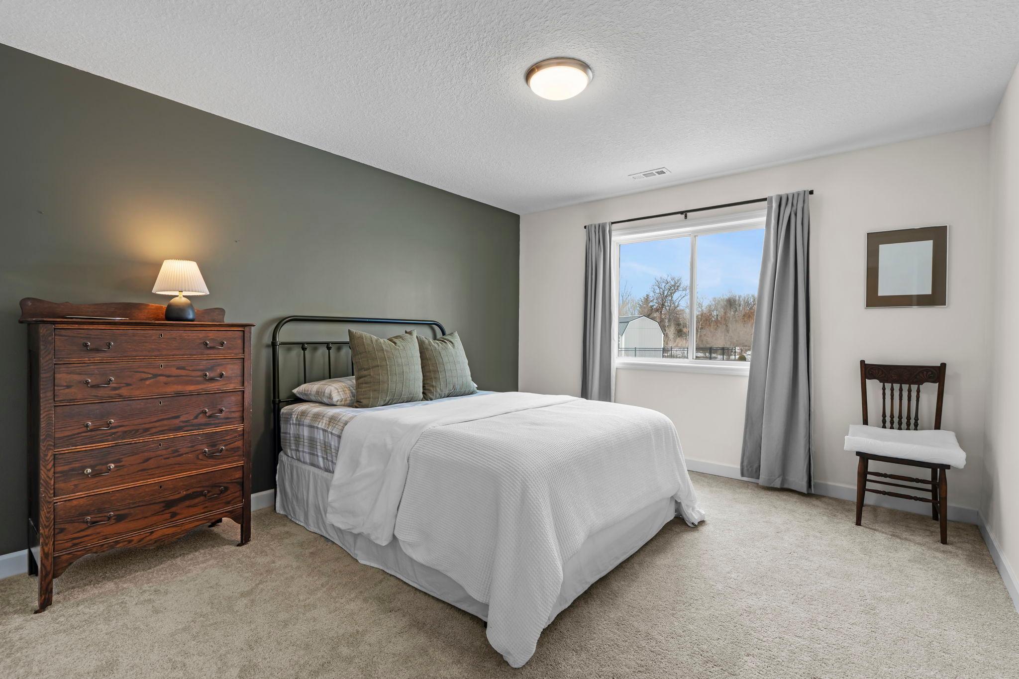 The 3rd bedroom is in the lower level and looks out to the backyard.