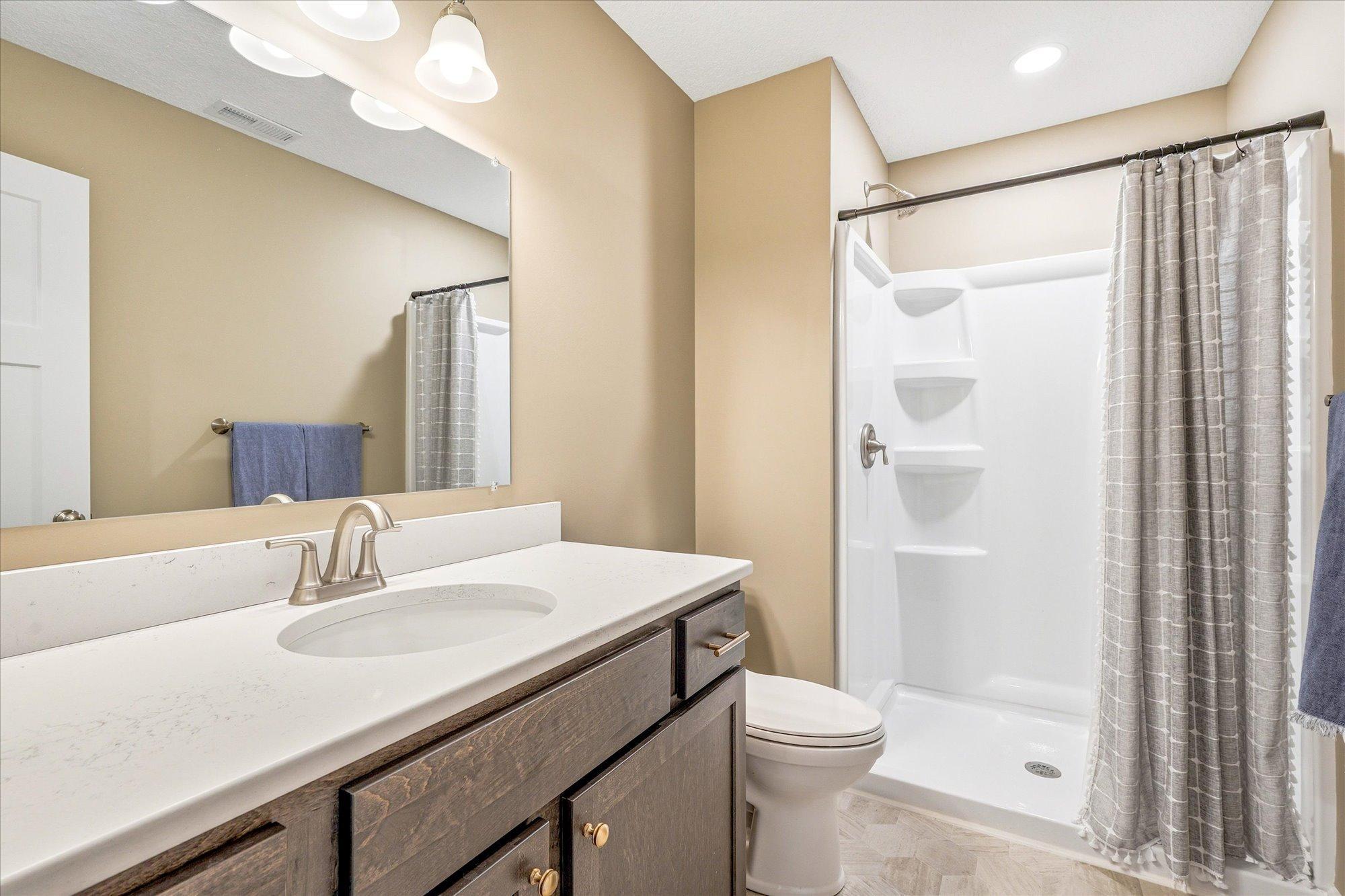 The lower level bathroom was finished to mimic the upper level style.