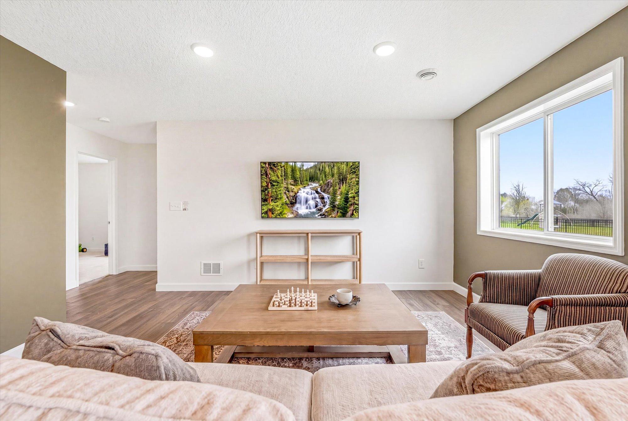 The lower level boasts a large living room, two additional bedrooms, AND a separate office.
