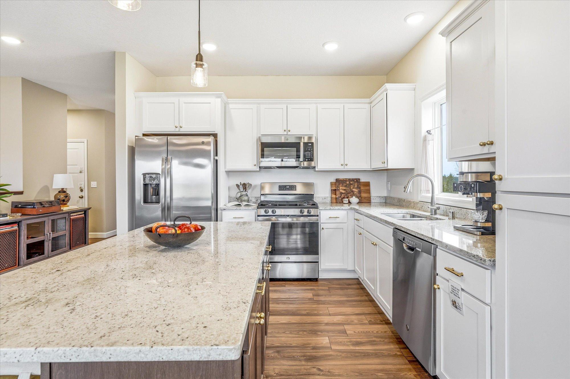 The brushed gold knobs give this kitchen a vibrant touch.