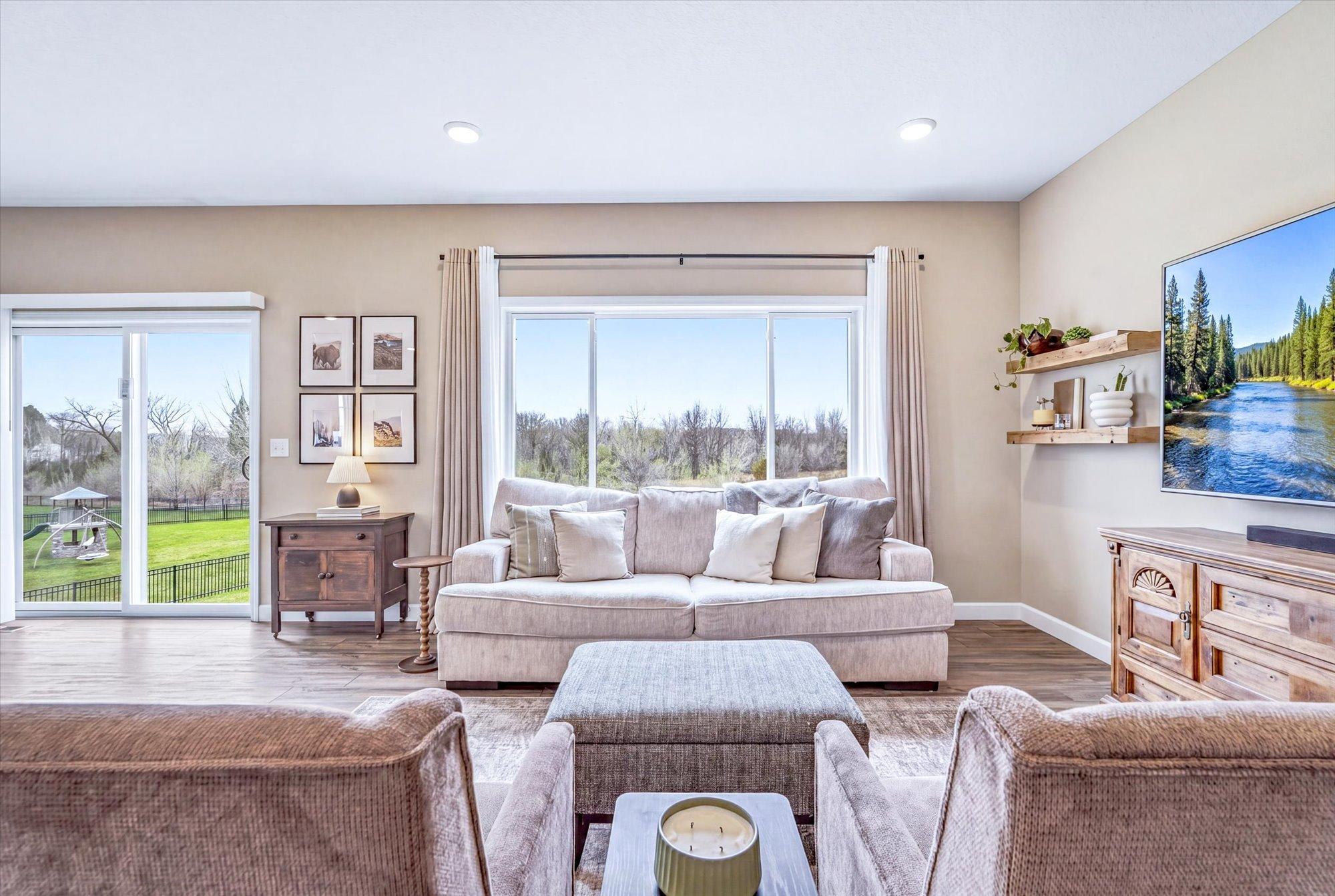 The living room features large windows for an abundance of natural light.