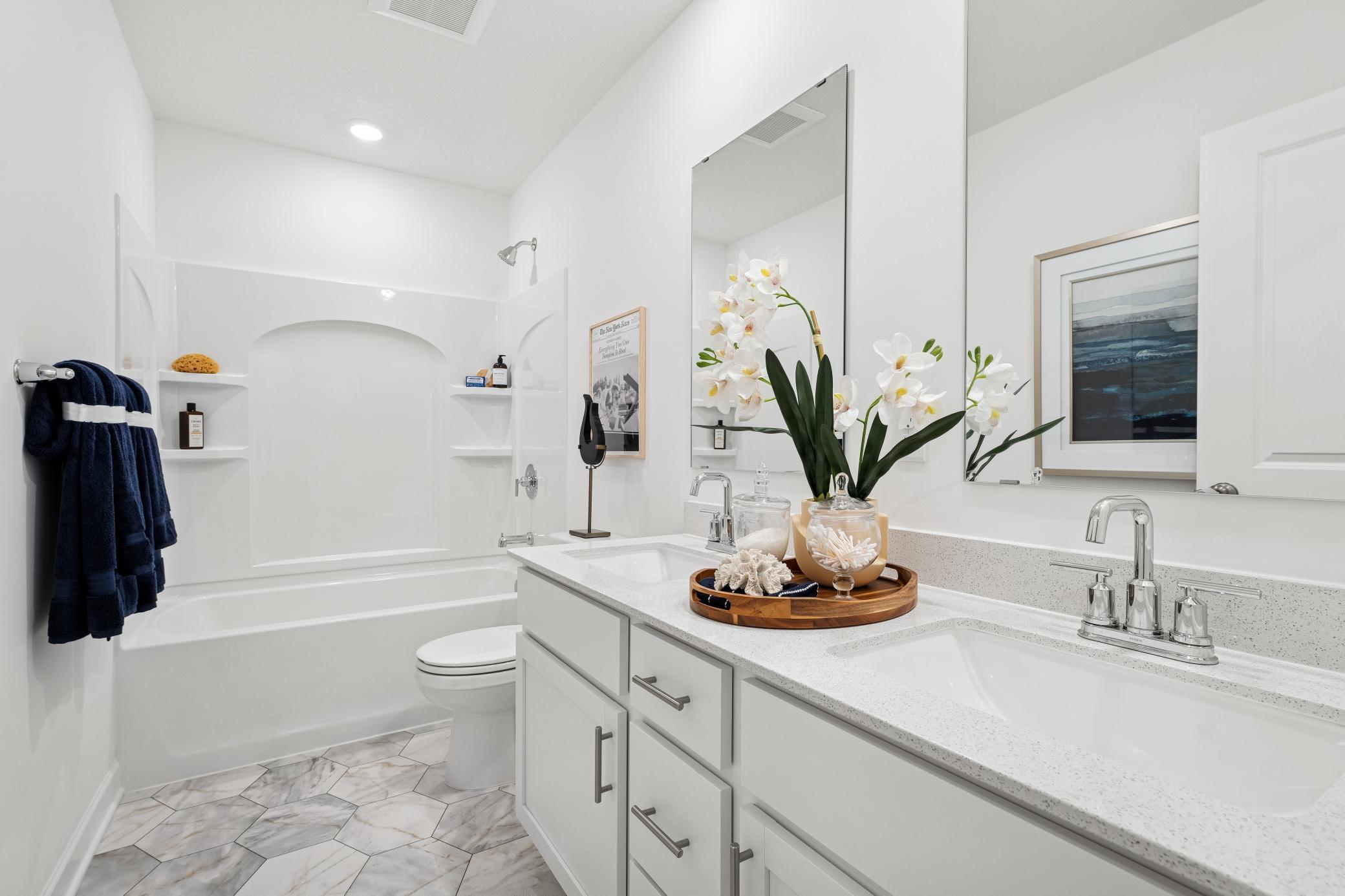 The home's secondary bath features a double-vanity to help keep everyone moving during those busy mornings.