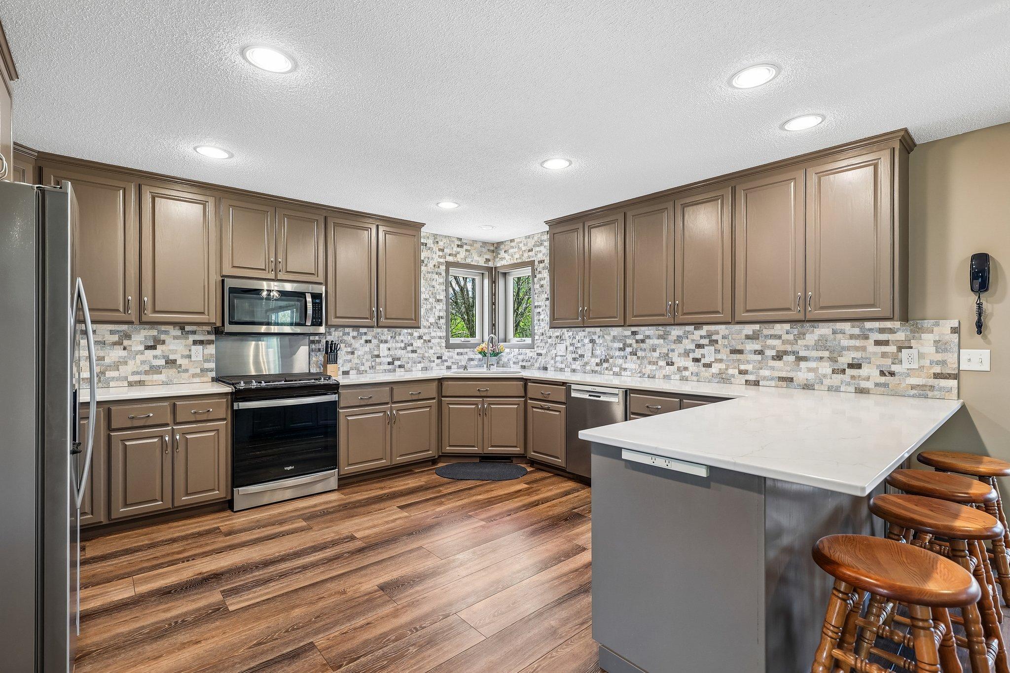 Completely renovated kitchen with new appliances, flooring, quartz counters, breakfast bar, pull out shelves and more.