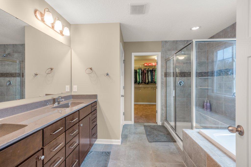 Private primary bathroom with separate shower and tub