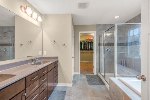 Private primary bathroom with separate shower and tub
