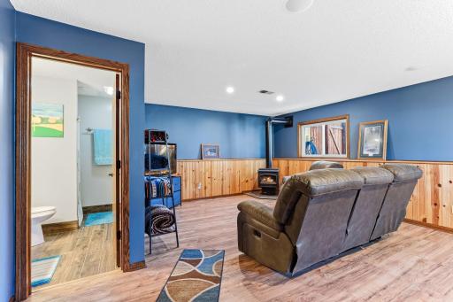 Large open family room in the lower level with gas fireplace and freshly painted