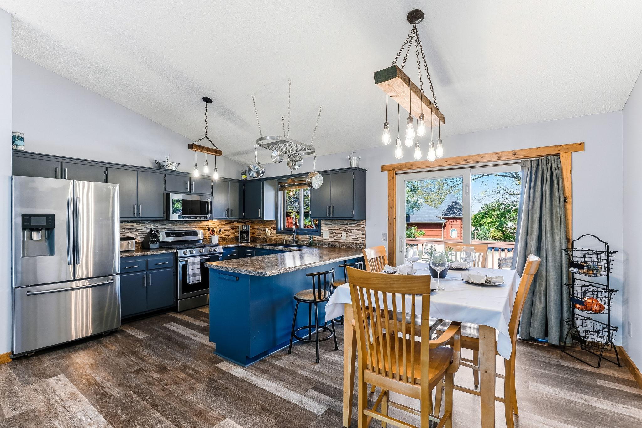 Beautiful kitchen with stainless steel appliances and tiled backsplash