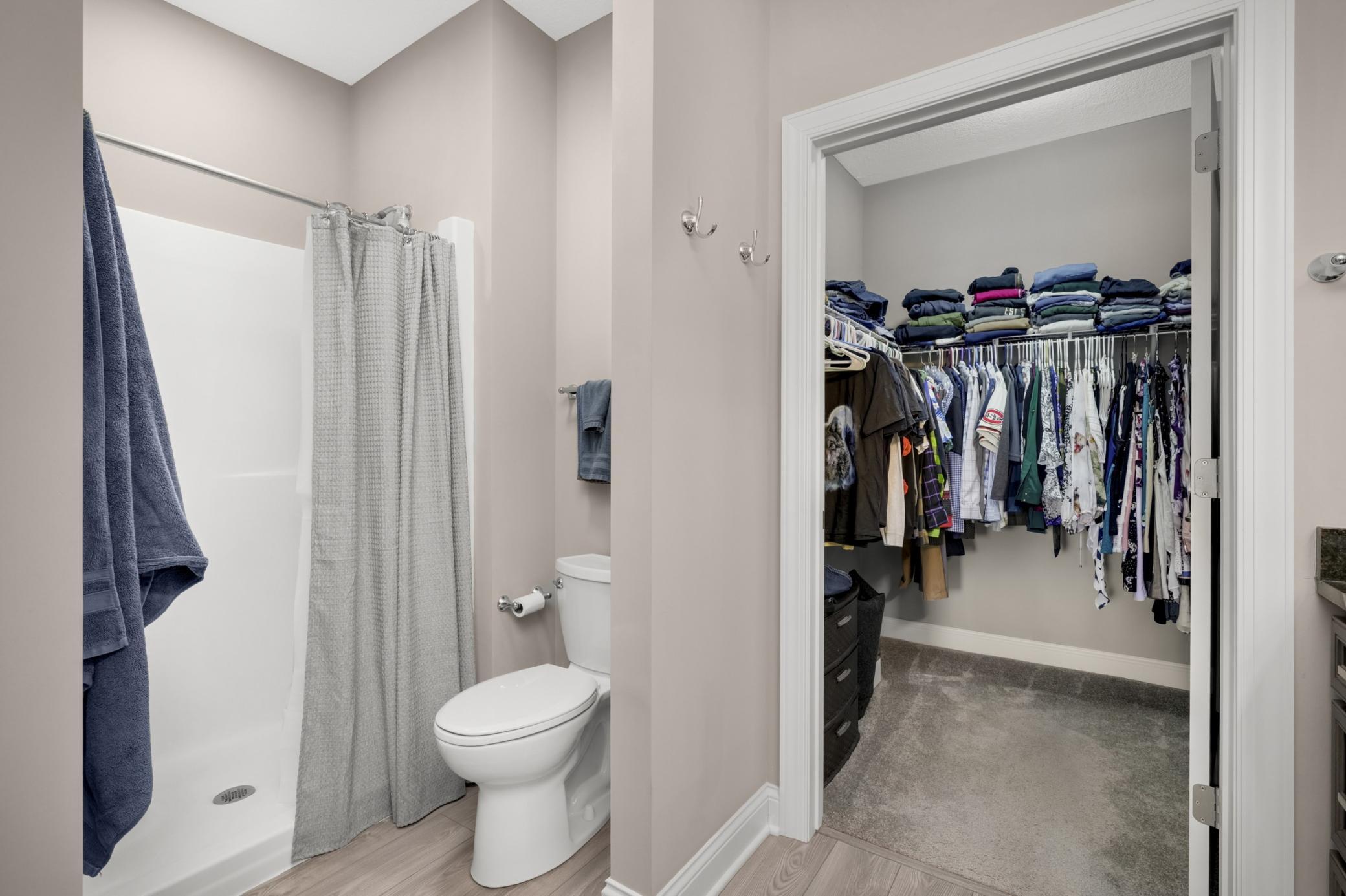 Private primary bathroom with walk-in closet