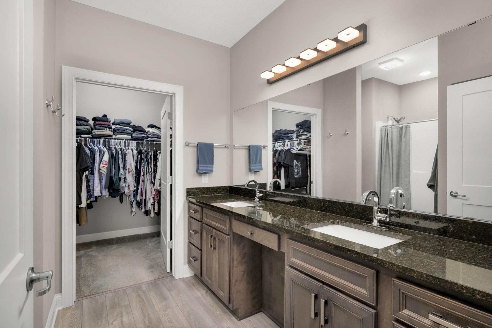 Private primary bathroom with walk-in closet