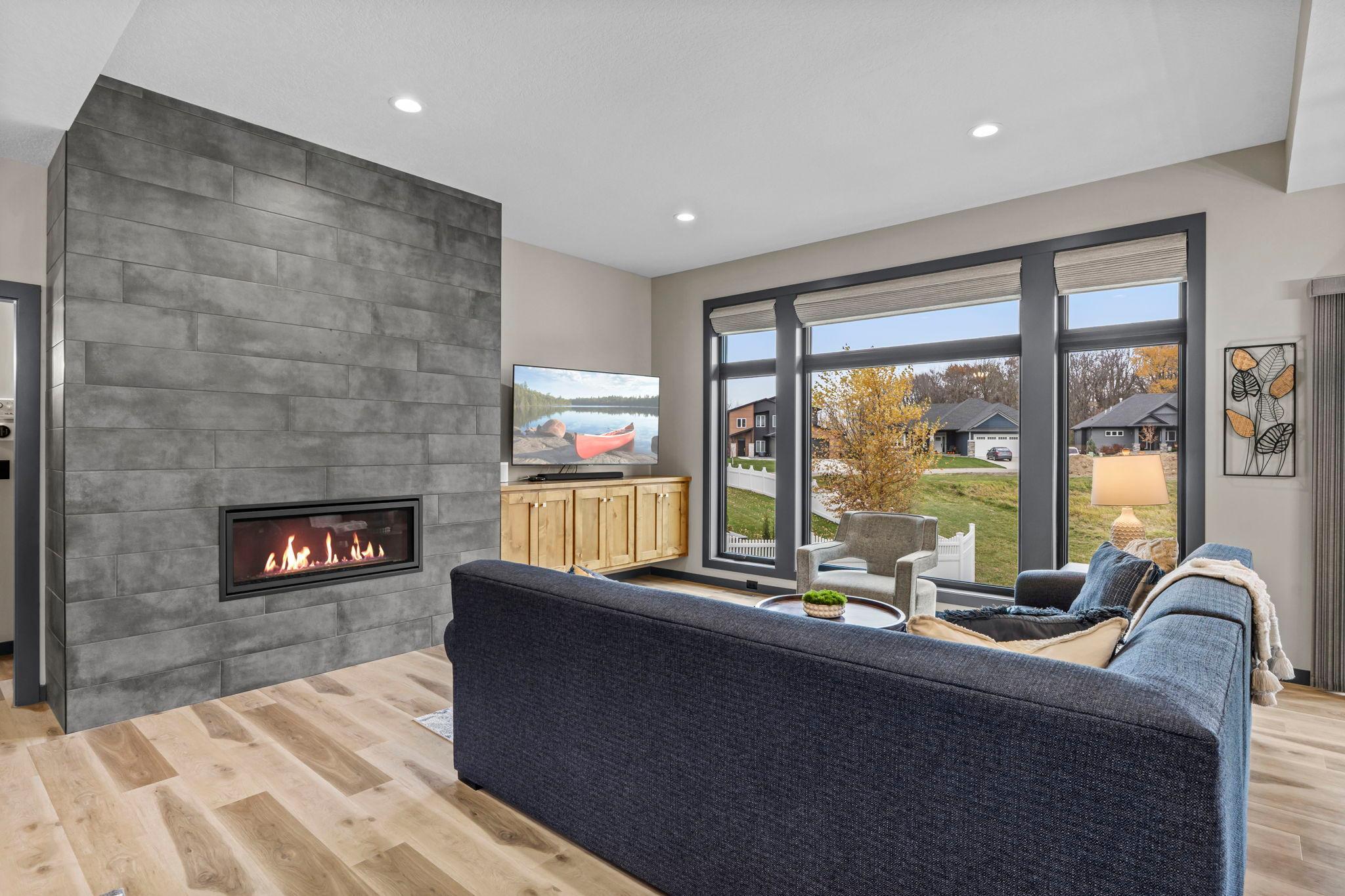 Living room includes a statement fireplace & built-ins