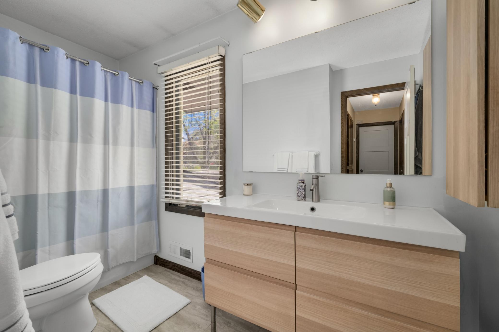 The upper level bathroom is newly updated with great storage