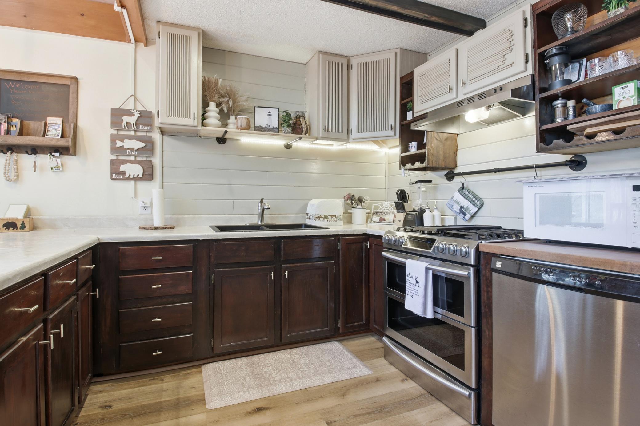 Undercabinet lighting and Stainless appliances highlight the kitchen.
