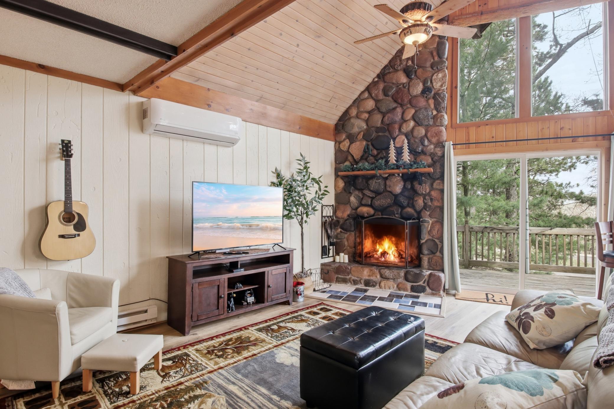 A wood burning fireplace creates a secondary heat options. Notice the real stone? It carries floor to ceiling and extends on the exterior for a "WOW" factor. A mini split is another resource for heating and air conditioning.