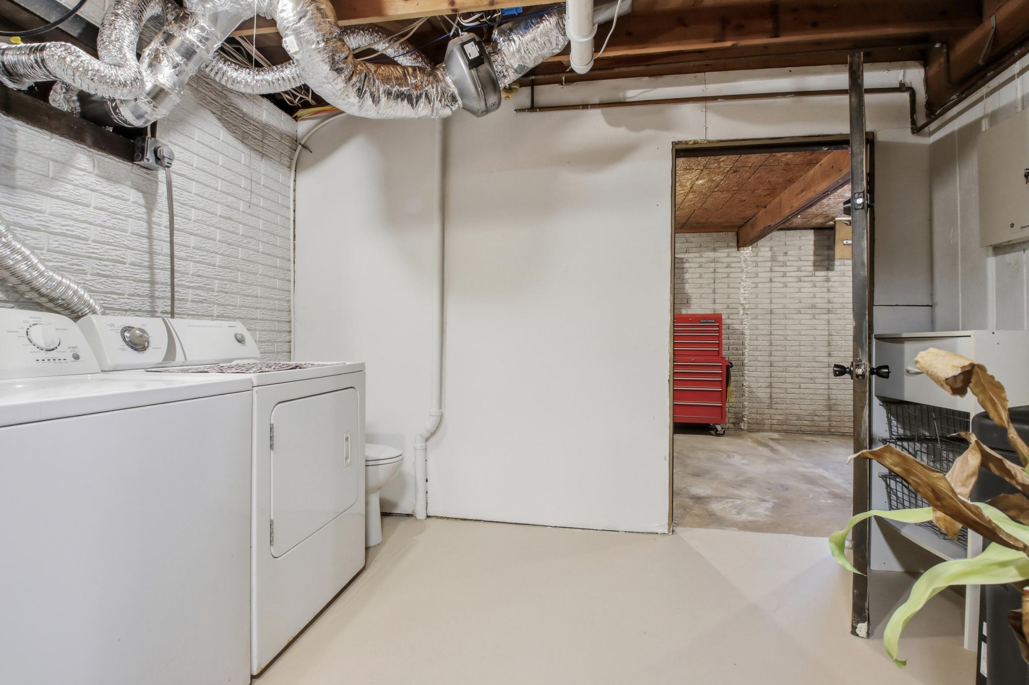 The lower level laundry area is also a 1/4 bath. Convenient for entry from the attached garage or while working out on the grounds. No need to go through the home to wash up.