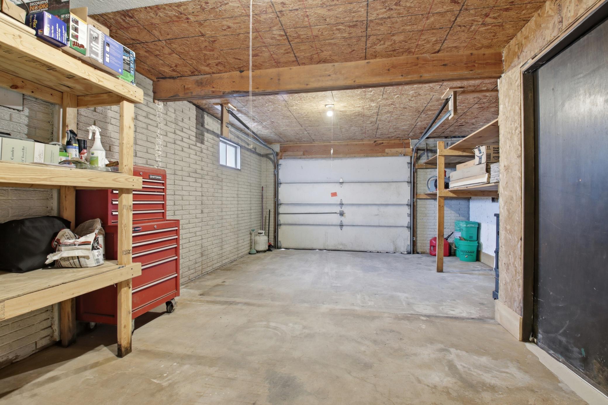 Interior attached single garage for snowmobiles or side by side storage. Some vehicles will fit.