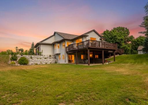 Enjoy outdoor living at its best with a large deck, covered patio, and thoughtfully updated landscaping surrounded by mature trees
