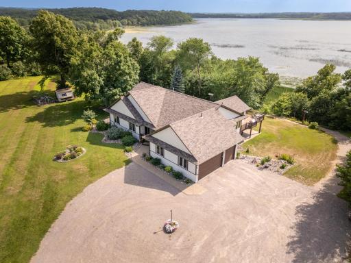 A wide, easy-access path leads from the driveway directly down to the lake