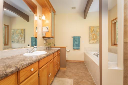 The ensuite bath combines everyday comfort with timeless finishes