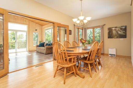 The dining room connects naturally with the living spaces and sunroom beyond