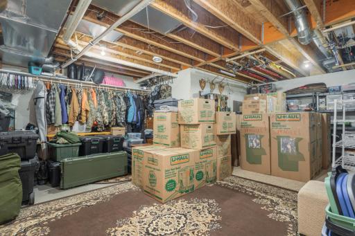 Huge lower-level storage and utility rooms offer endless possibilities for storage, a workshop, or hobby space
