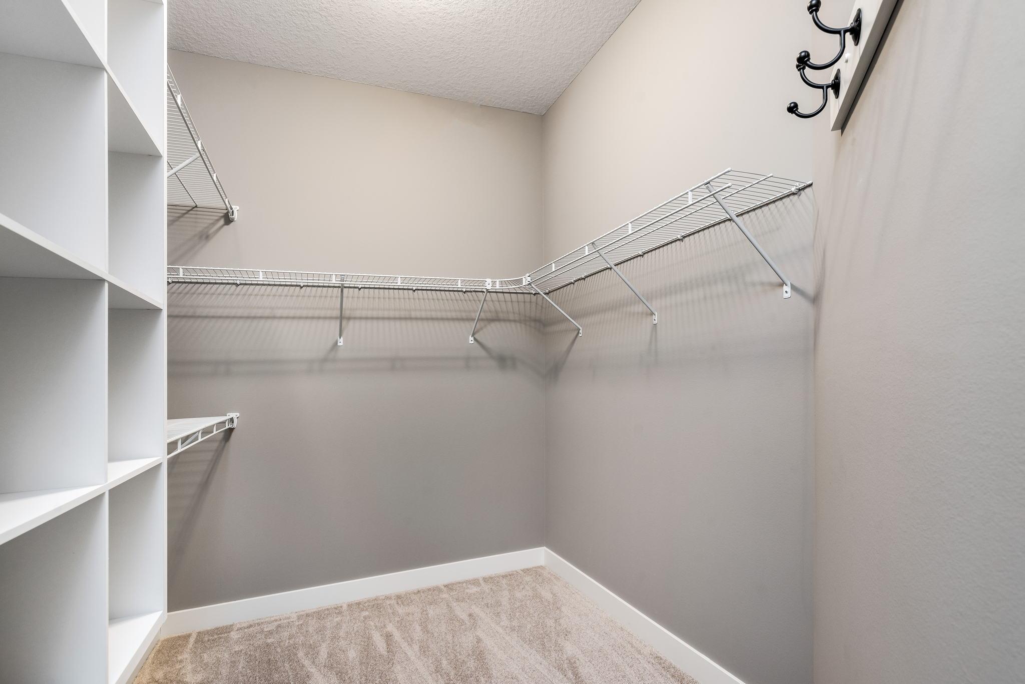 Primary bedroom walk-in closet