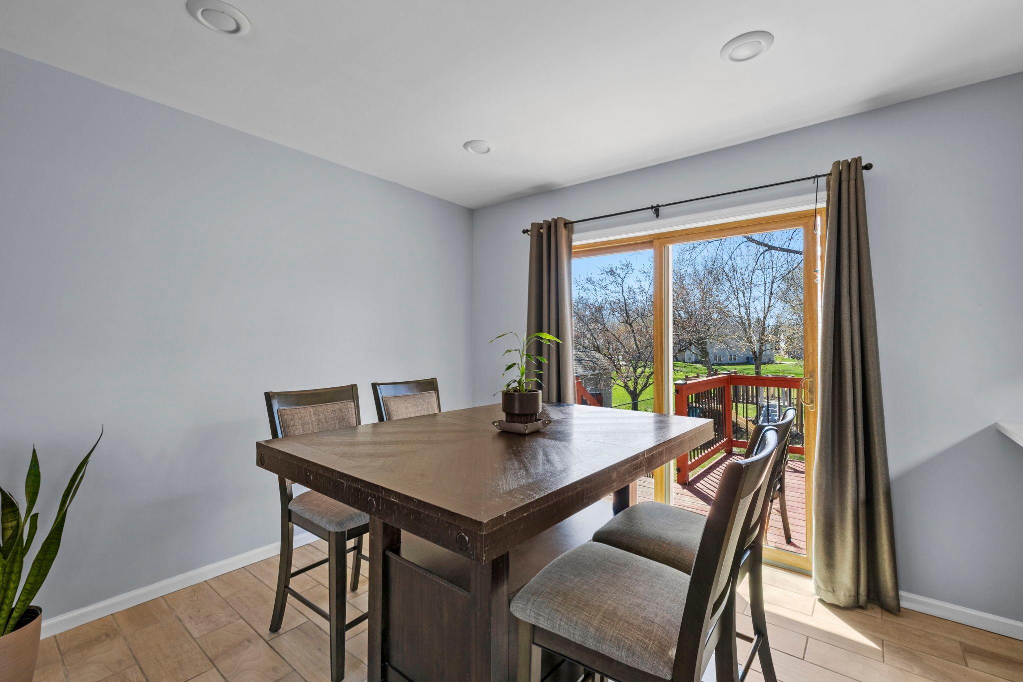 The adjoining dining area opens directly to an oversized deck, perfect for extending gatherings outside or enjoying a quiet morning.
