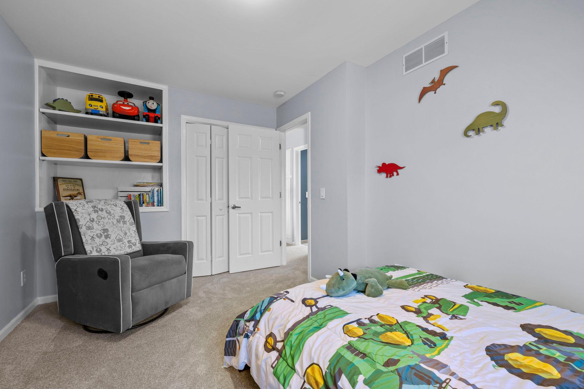 The second bedroom has great closet space and built-in shelving for decor and organization.