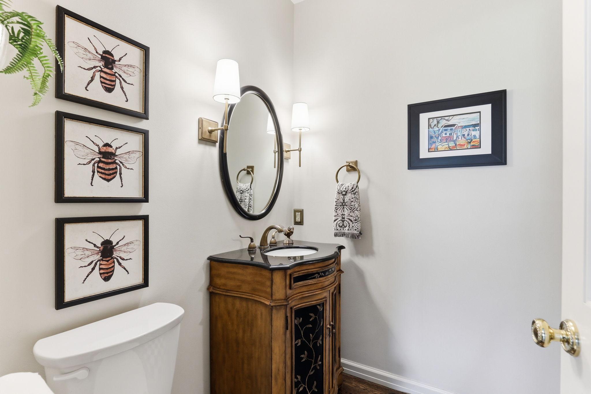 Warm tones and premium finishes create a welcoming atmosphere, making the main level half bath both functional and visually striking.